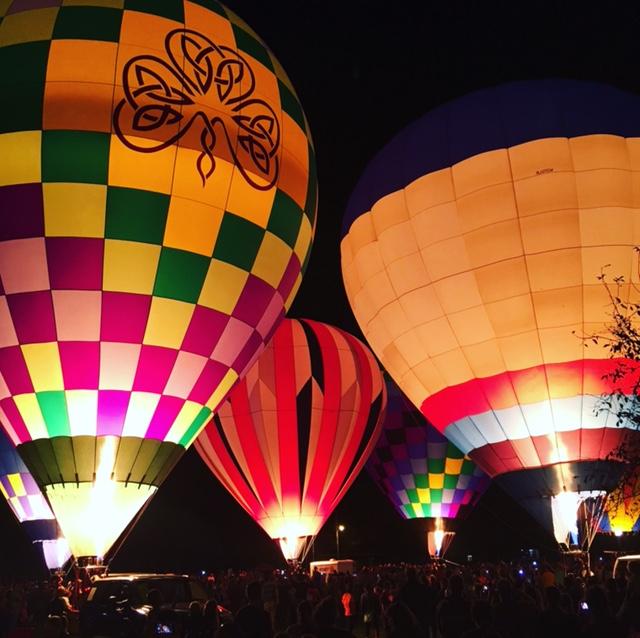 Some hot air balloons lit up on Friars Field